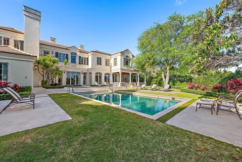 a bedroom with furniture and a large window
