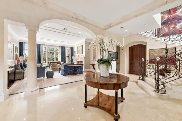 a living room with furniture and a bookshelf