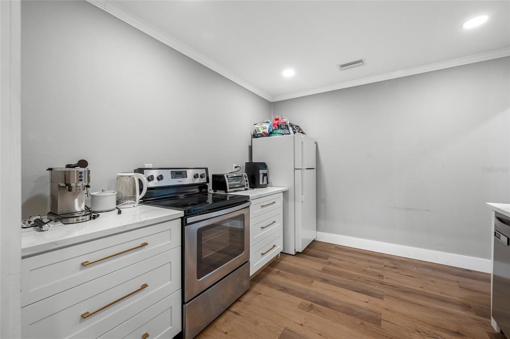 620 Union Street Dunedin, FL 34698 - Photo 18 of 45 a kitchen with a stove cabinets and wooden floor