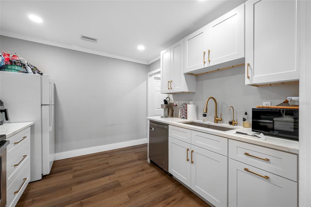 620 Union Street Dunedin, FL 34698 - Photo 19 of 45 a kitchen with stainless steel appliances granite countertop a refrigerator sink and cabinets