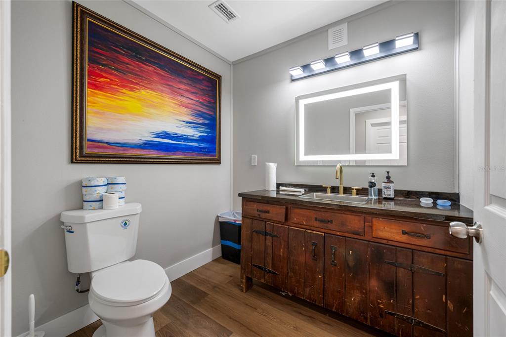 620 Union Street Dunedin, FL 34698 - Photo 20 of 45 a bathroom with a toilet a sink and mirror
