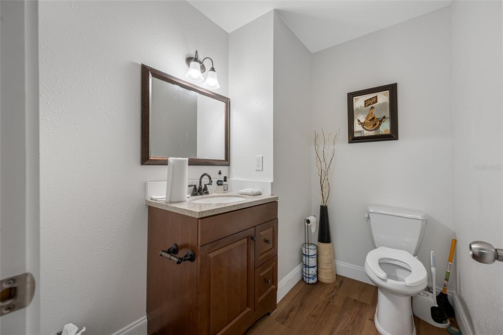 620 Union Street Dunedin, FL 34698 - Photo 29 of 45 a bathroom with a toilet sink vanity and mirror