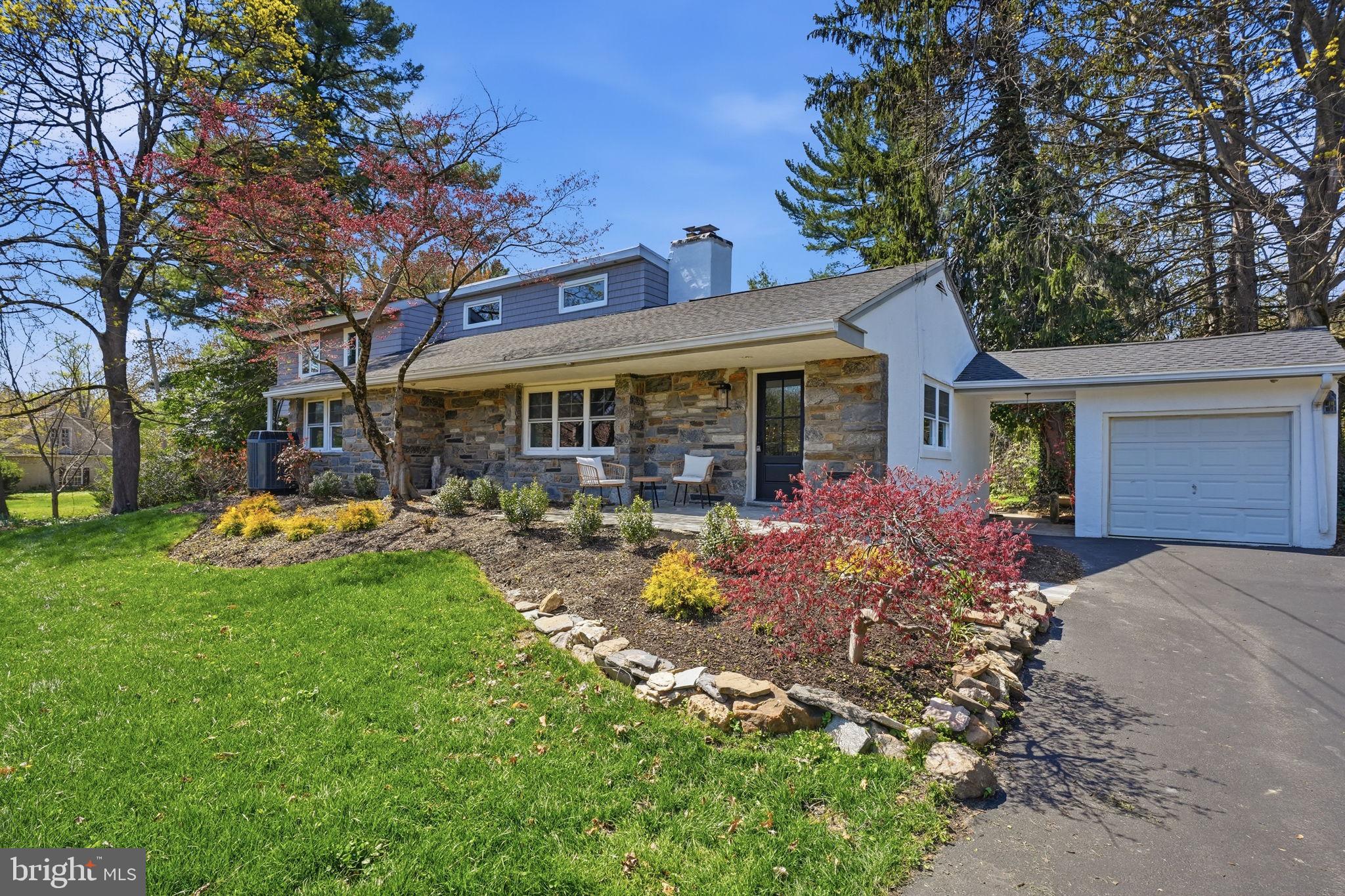 a view of a house with sitting area and garden
