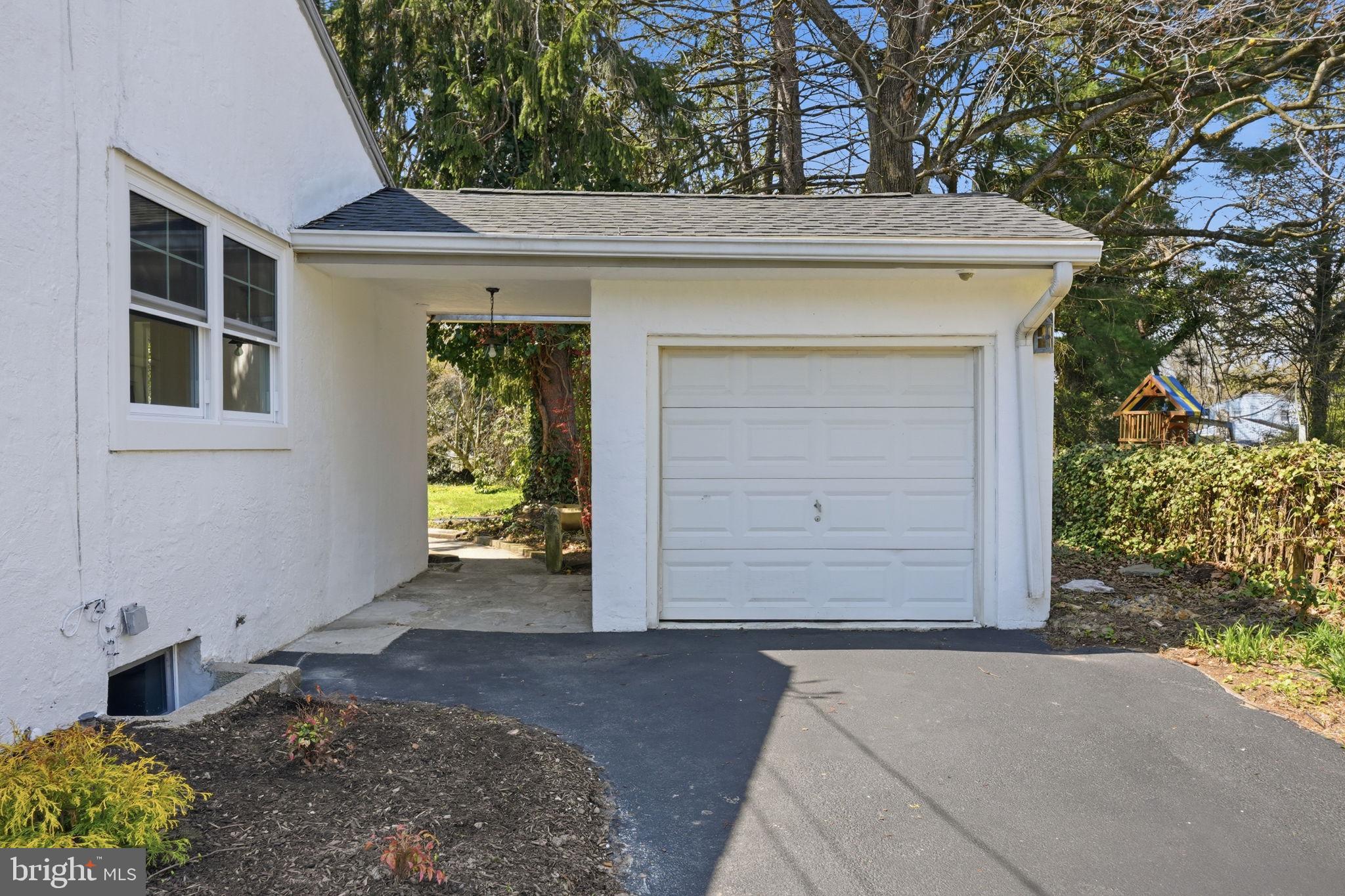 409 South Providence Road Wallingford, PA 19086 - Photo 3 of 106 Charming garage entry with greenery.