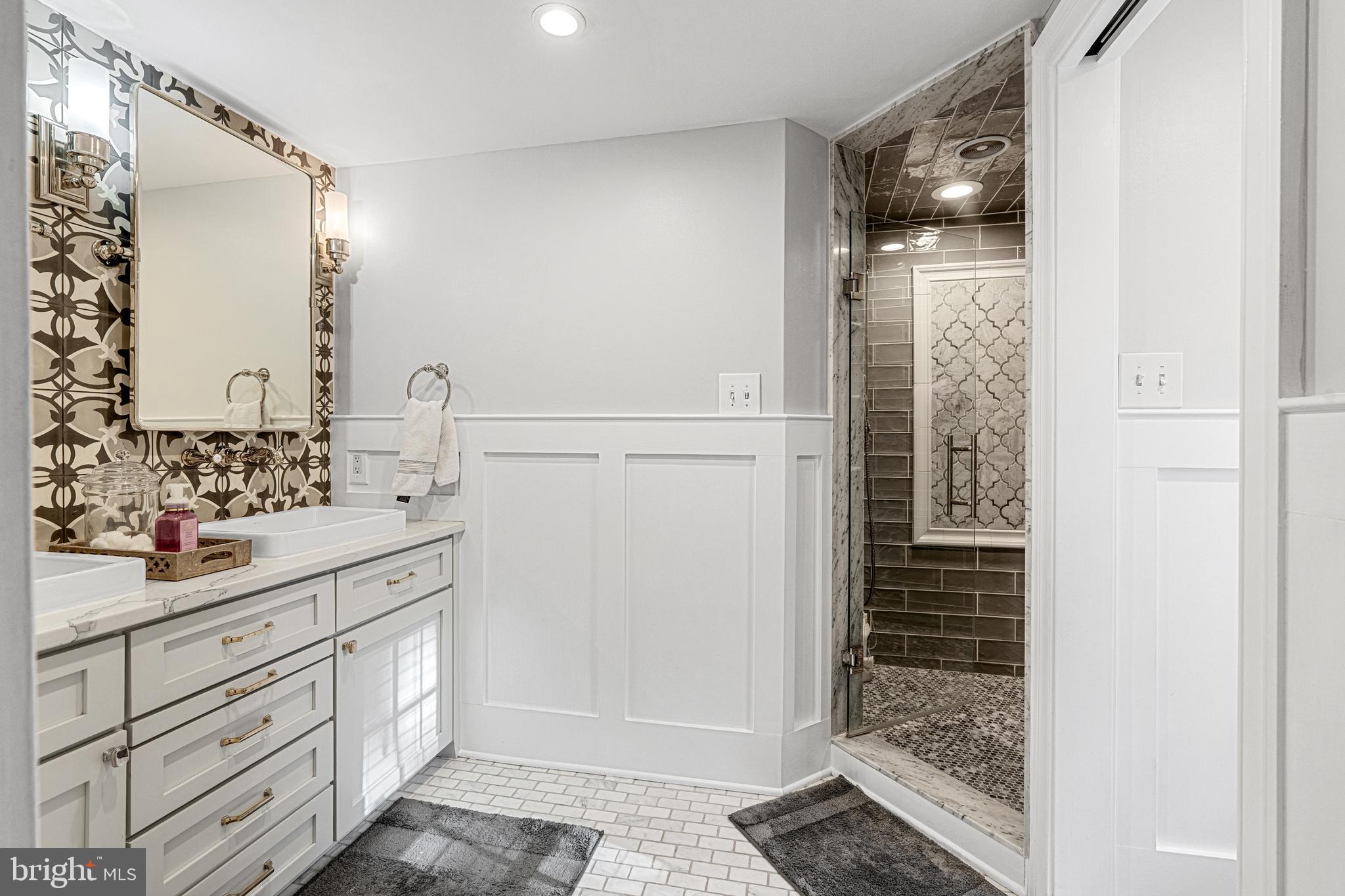 1141 Lafayette Road Wayne, PA 19087 - Photo 26 of 64 a bathroom with a shower sink and mirror