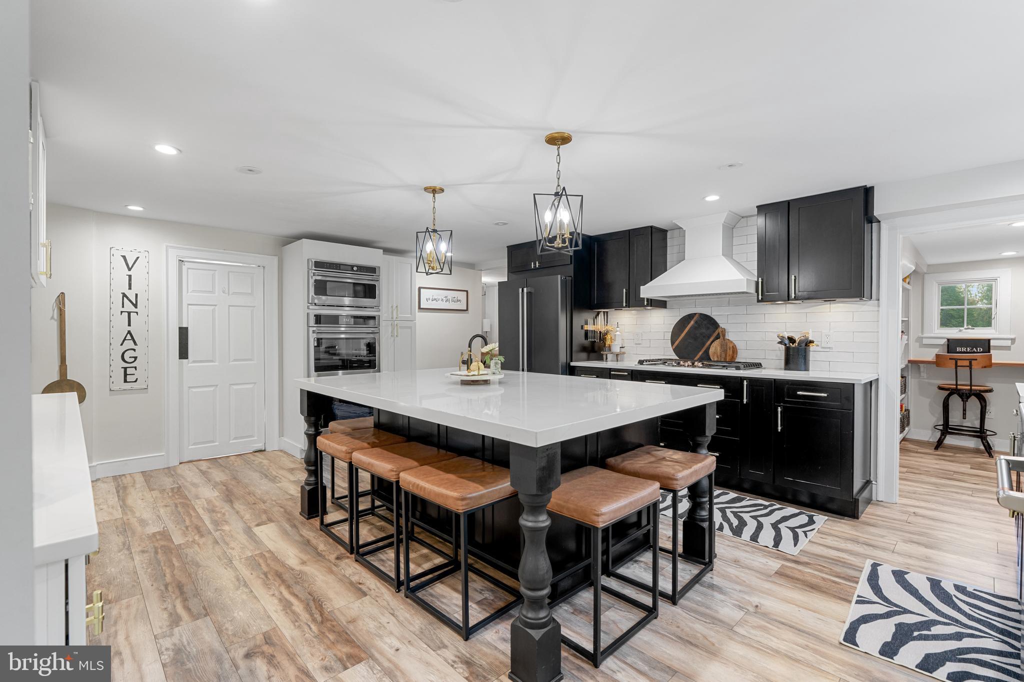 1141 Lafayette Road Wayne, PA 19087 - Photo 6 of 64 a kitchen with stainless steel appliances a dining table chairs stove refrigerator and cabinets