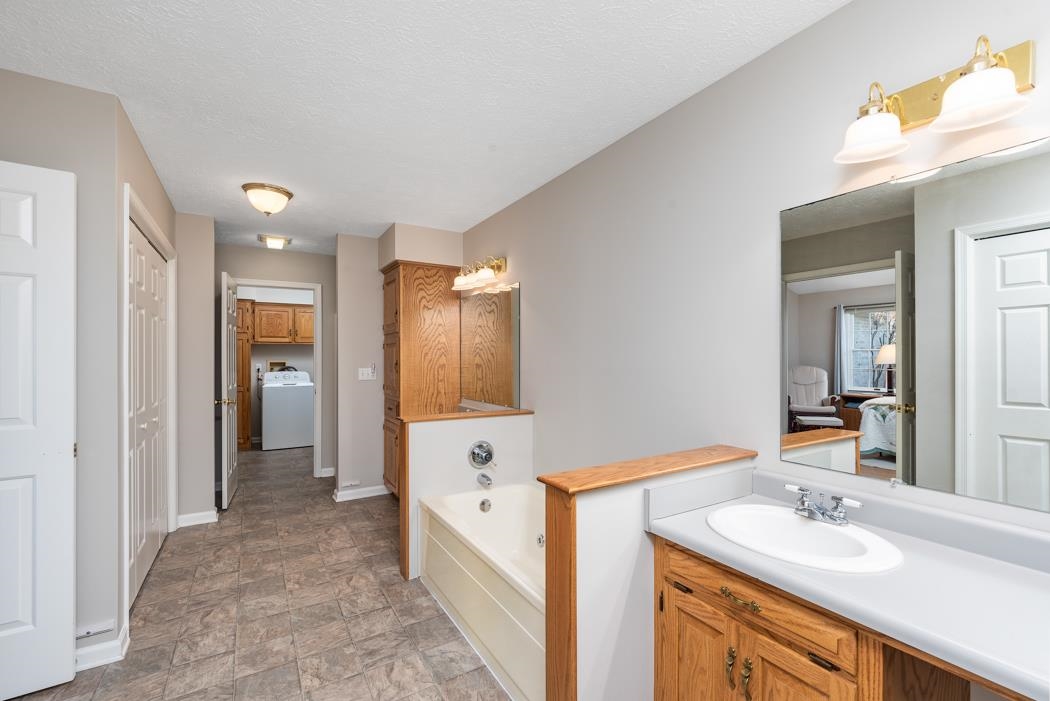 88 Cranberry Drive Stuarts Draft, VA 24477 - Photo 38 of 67 a bathroom with a sink a mirror and a bathtub