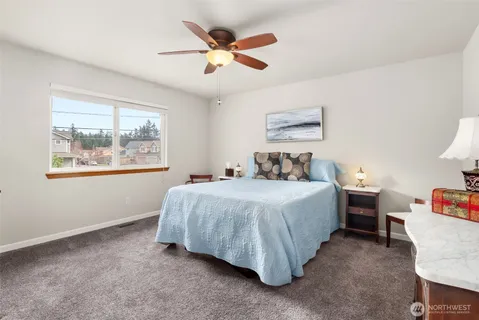 a bedroom with a bed and a painting on the wall