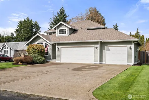 a front view of a house with a garden and yard