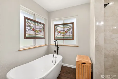a bathroom with a bathtub and a window