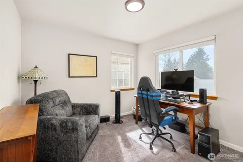 a livingroom with workspace and a couch
