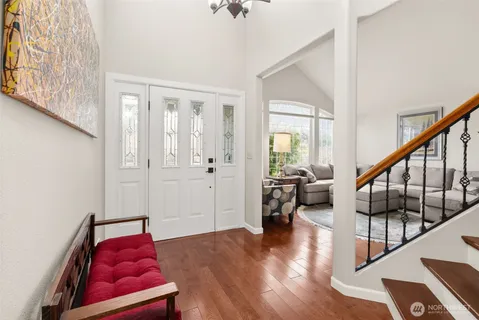 a view of entryway bedroom and hall with wooden floor
