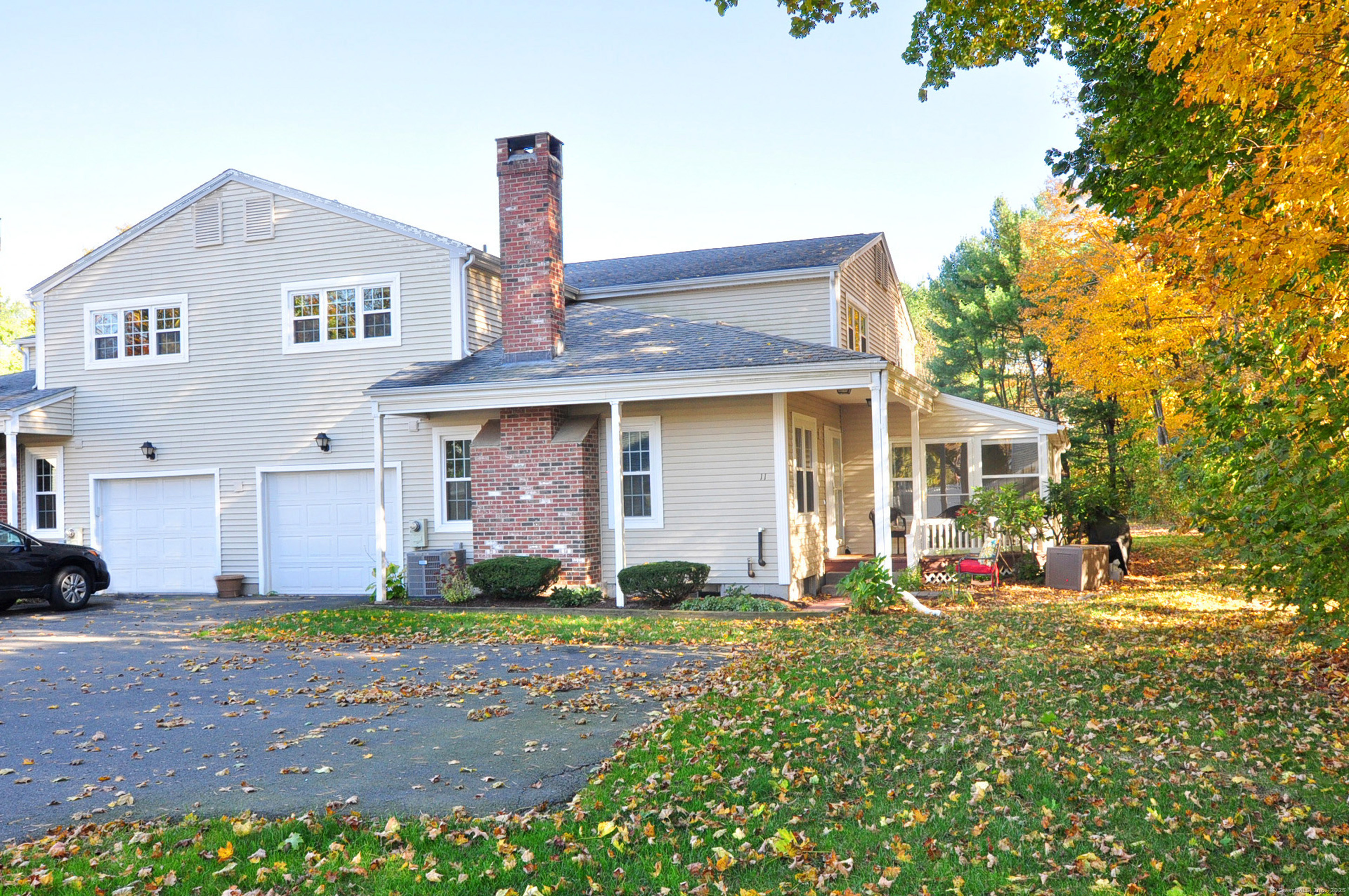 a front view of a house with a yard and seating space
