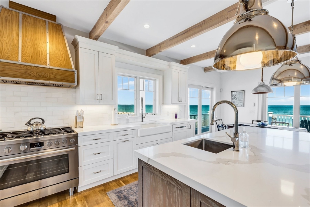 57 Salt Marsh Road Sandwich, MA 02537 - Photo 11 of 41 a kitchen with stainless steel appliances a sink a stove and cabinets