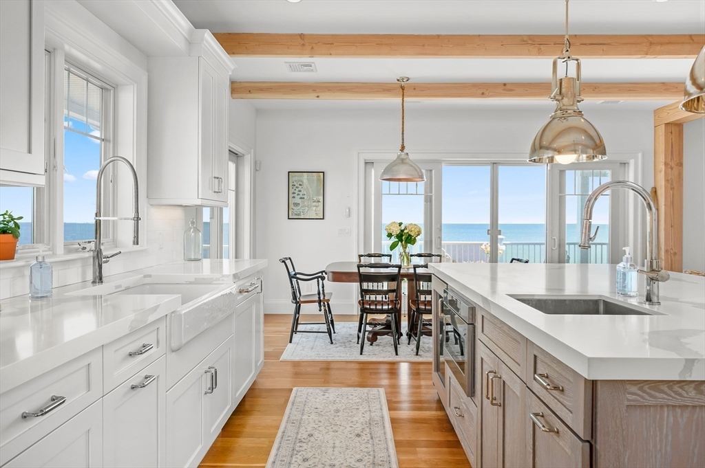 57 Salt Marsh Road Sandwich, MA 02537 - Photo 13 of 41 a kitchen with counter top space cabinets and living room view