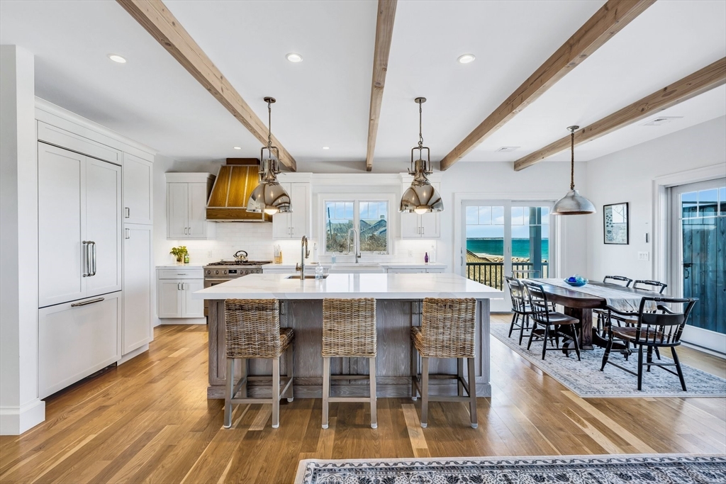 57 Salt Marsh Road Sandwich, MA 02537 - Photo 14 of 41 a dining hall with stainless steel appliances kitchen island granite countertop a dining table chairs and view living room