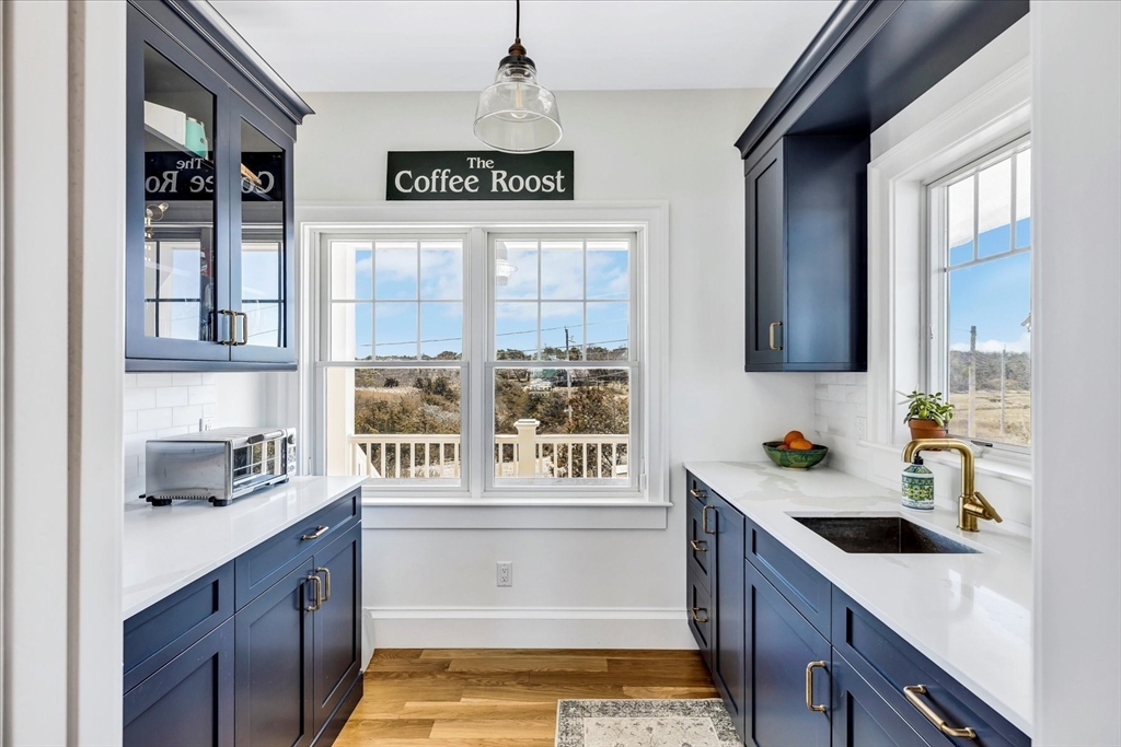 57 Salt Marsh Road Sandwich, MA 02537 - Photo 15 of 41 a kitchen with a sink stove and cabinets