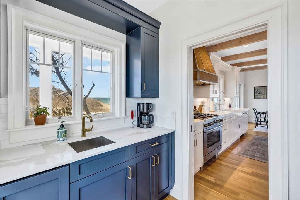 57 Salt Marsh Road Sandwich, MA 02537 - Photo 16 of 41 a large kitchen with kitchen island granite countertop a sink and a stove top oven
