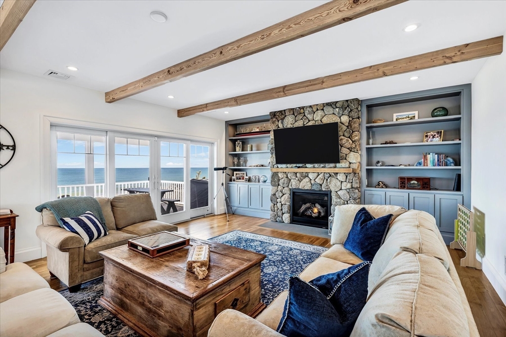 57 Salt Marsh Road Sandwich, MA 02537 - Photo 18 of 41 a living room with furniture a fireplace and a flat screen tv