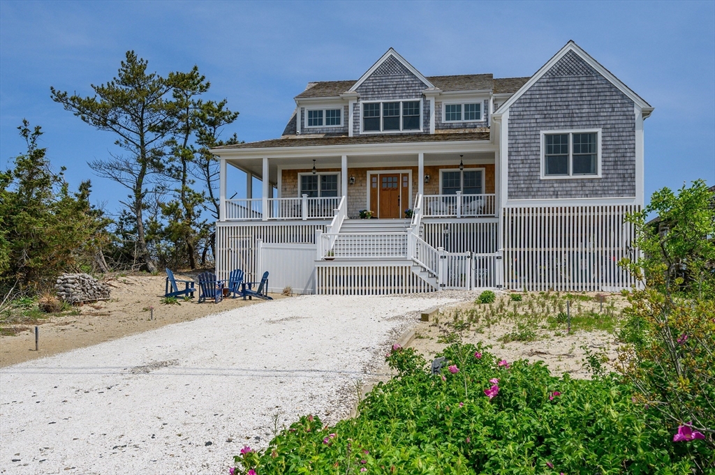57 Salt Marsh Road Sandwich, MA 02537 - Photo 2 of 41 a front view of a house with a yard