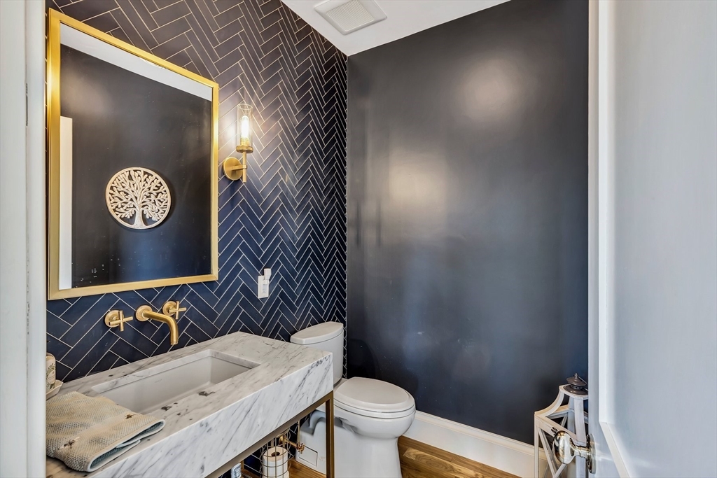 57 Salt Marsh Road Sandwich, MA 02537 - Photo 21 of 41 a bathroom with a sink a toilet and mirror