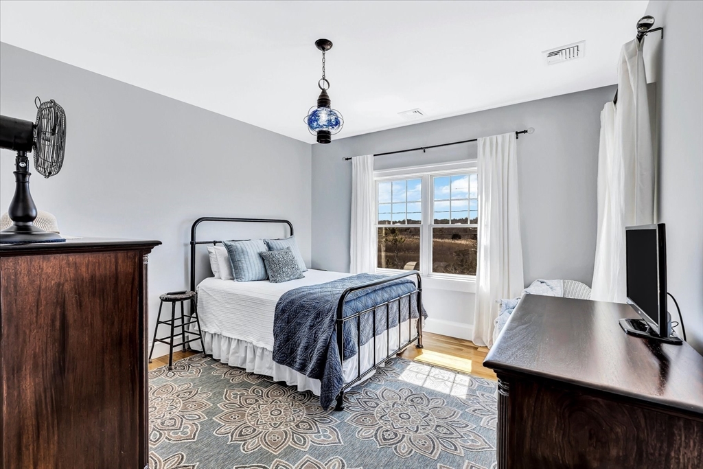 57 Salt Marsh Road Sandwich, MA 02537 - Photo 22 of 41 a bedroom with a bed and a flat screen tv