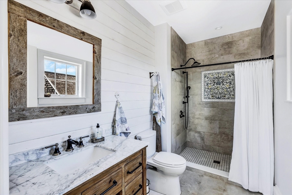 57 Salt Marsh Road Sandwich, MA 02537 - Photo 24 of 41 a bathroom with a sink a toilet and shower