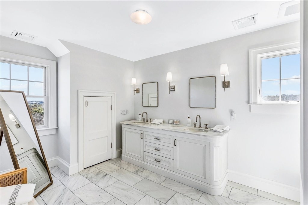 57 Salt Marsh Road Sandwich, MA 02537 - Photo 33 of 41 a spacious bathroom with a double vanity sink a mirror and a shower