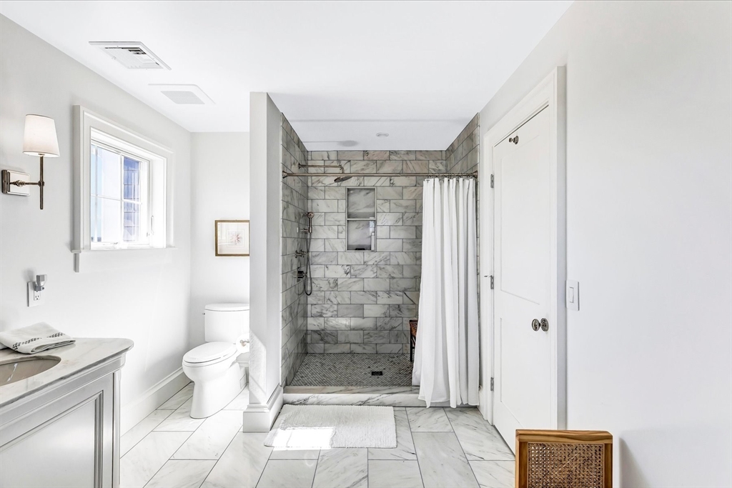 57 Salt Marsh Road Sandwich, MA 02537 - Photo 34 of 41 a bathroom with a granite countertop shower a toilet and a sink