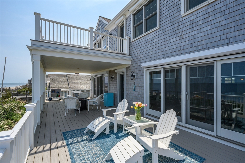 57 Salt Marsh Road Sandwich, MA 02537 - Photo 5 of 41 a view of a patio with table and chairs and wooden floor