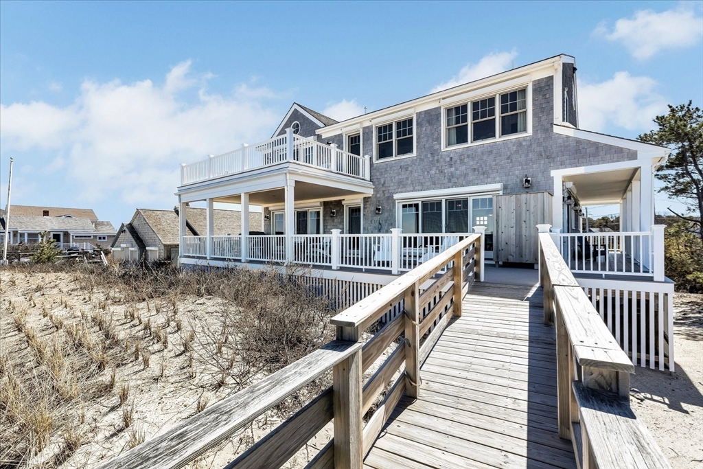 57 Salt Marsh Road Sandwich, MA 02537 - Photo 6 of 41 a front view of a house with wooden stairs