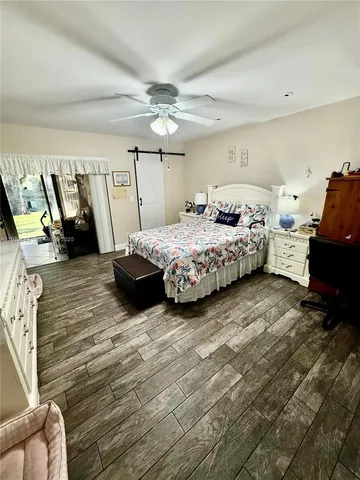 a spacious bedroom with a bed and a mirror