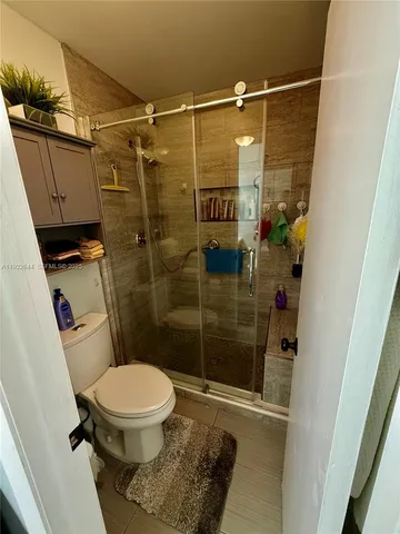 a bathroom with a toilet and a shower