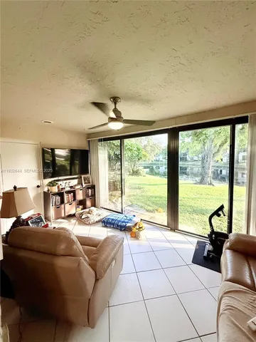 a living room with furniture and large windows