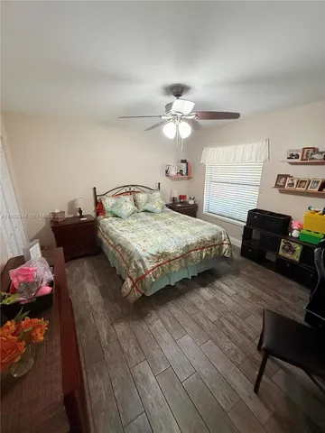a bedroom with bed and a chandelier