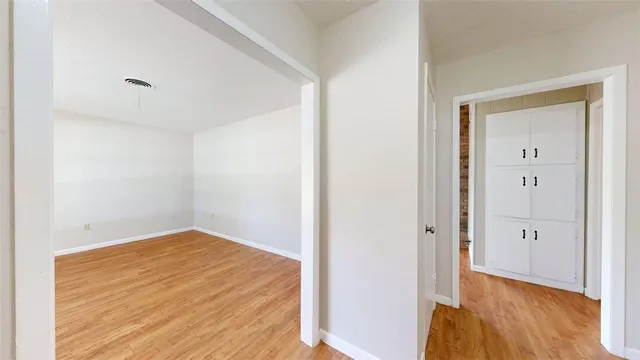 an empty room with wooden floor