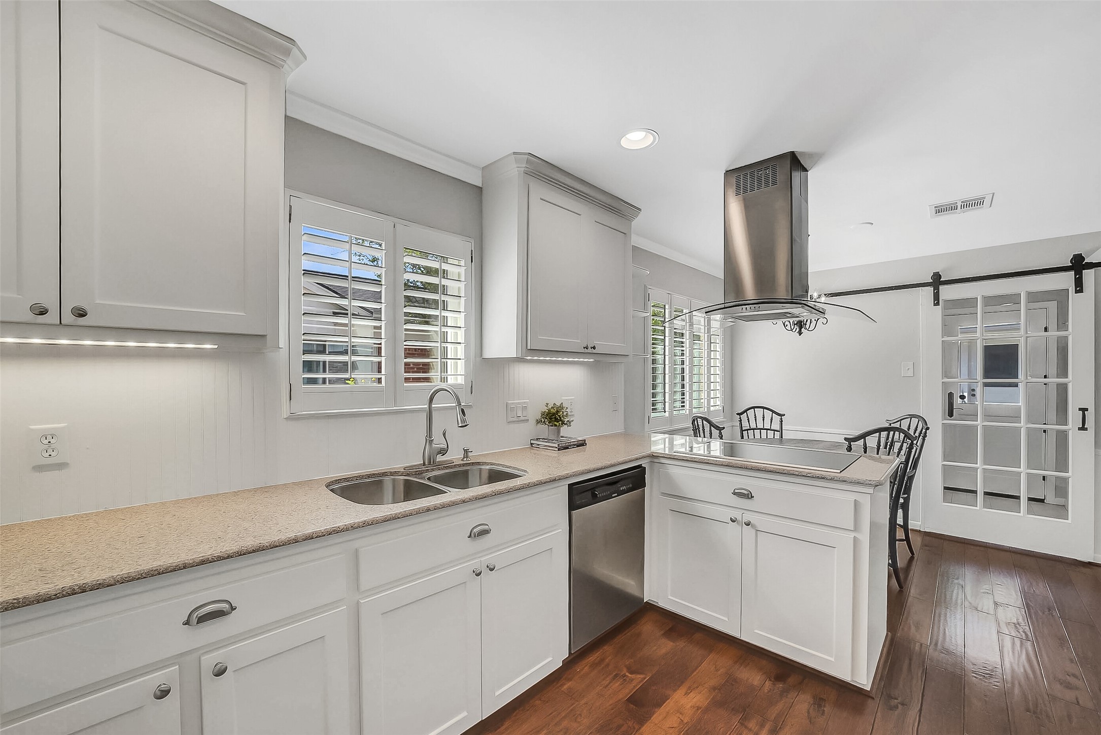 10026 Overbrook Lane Houston, TX 77042 - Photo 15 of 29 Thoughtfully designed kitchen opens to the breakfast area on the right and offers easy access to the utility room (thought the sliding door) w/ a pantry storage closet.