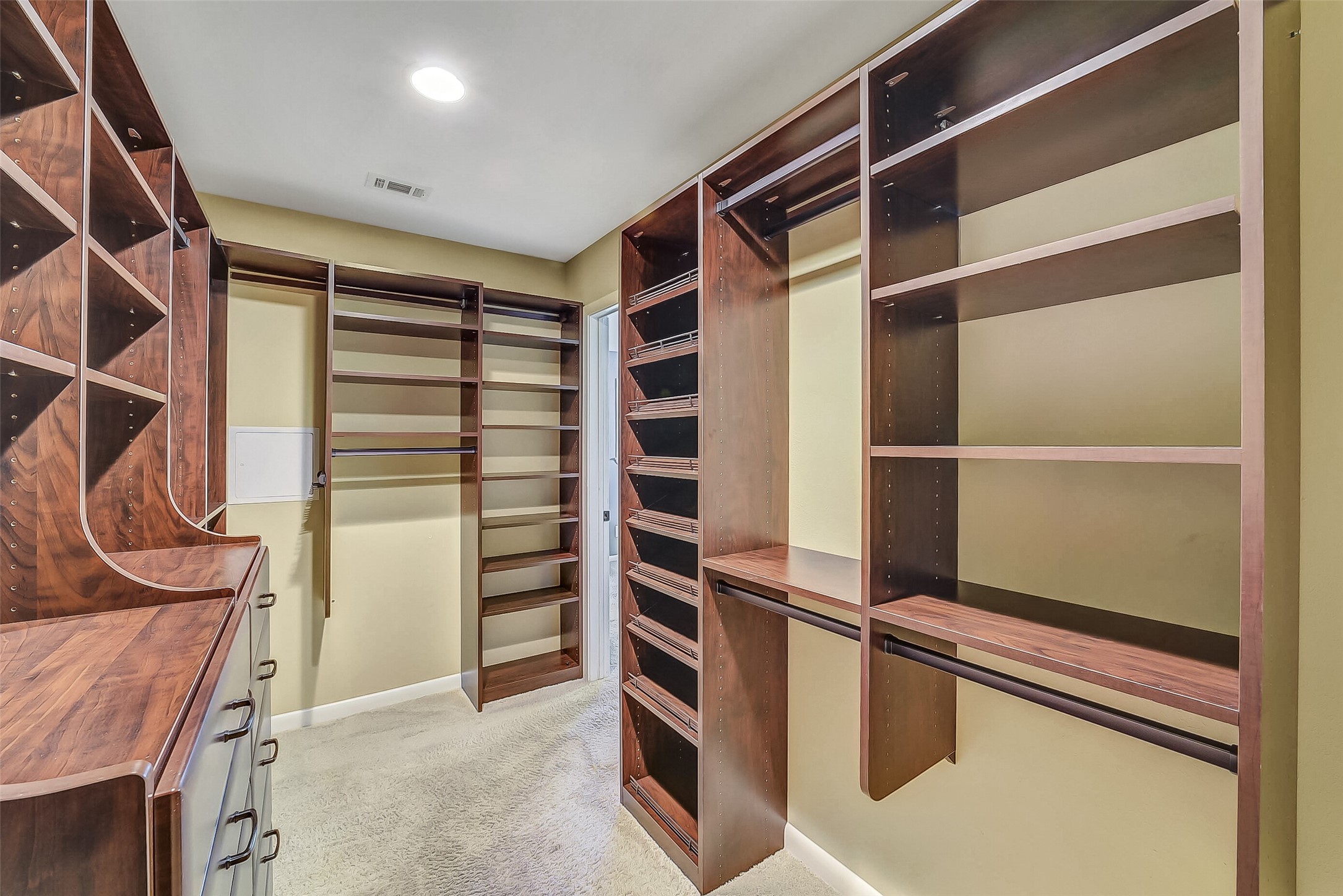10026 Overbrook Lane Houston, TX 77042 - Photo 20 of 29 Primary closet completely redone by California Closets for maximum storage. Built-in dresser and shelves.