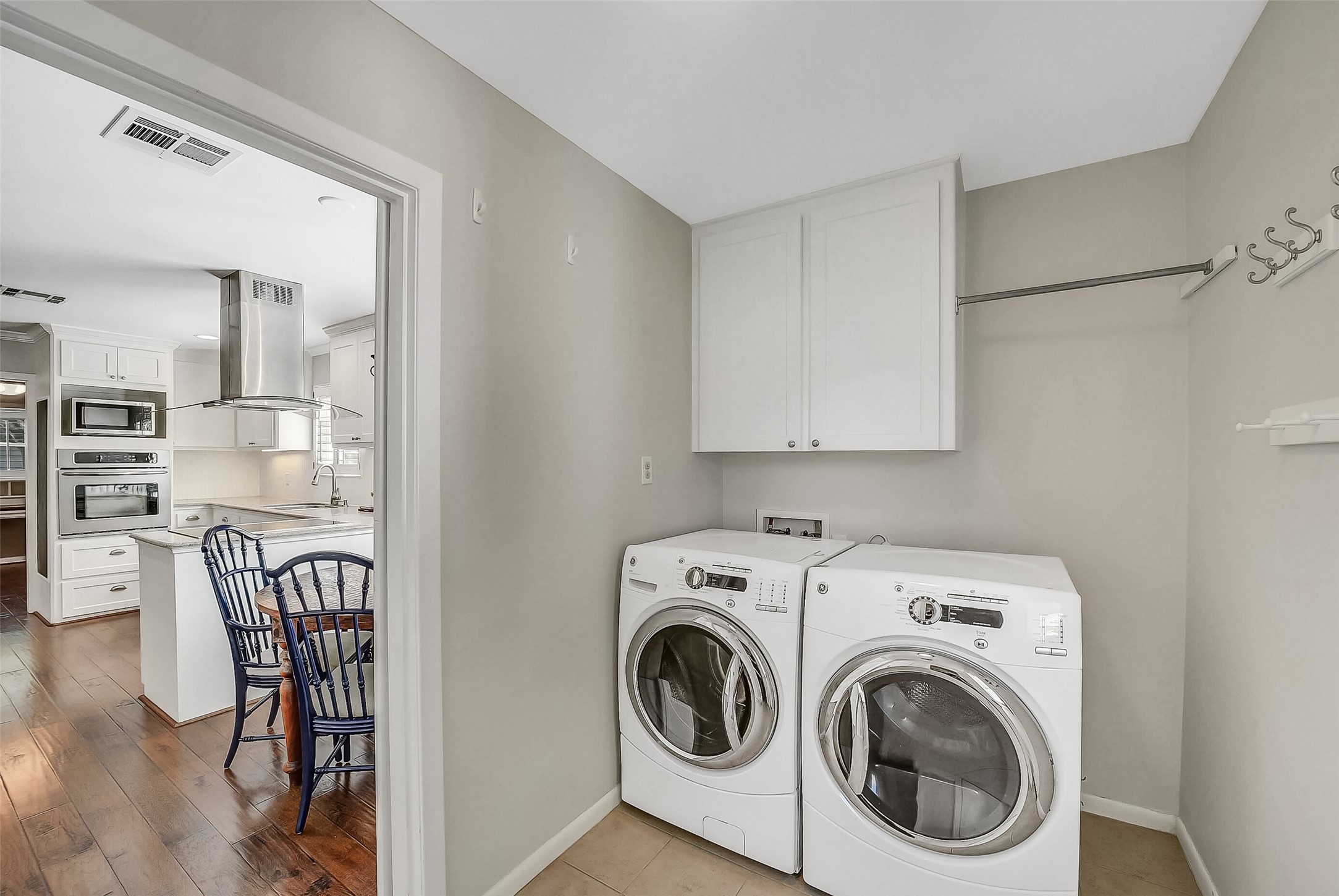 10026 Overbrook Lane Houston, TX 77042 - Photo 24 of 29 Convenient utility room with washer/dryer connections, storage cabinets and closet and dry hanging bar. Not shown is a door that leads to outside.
