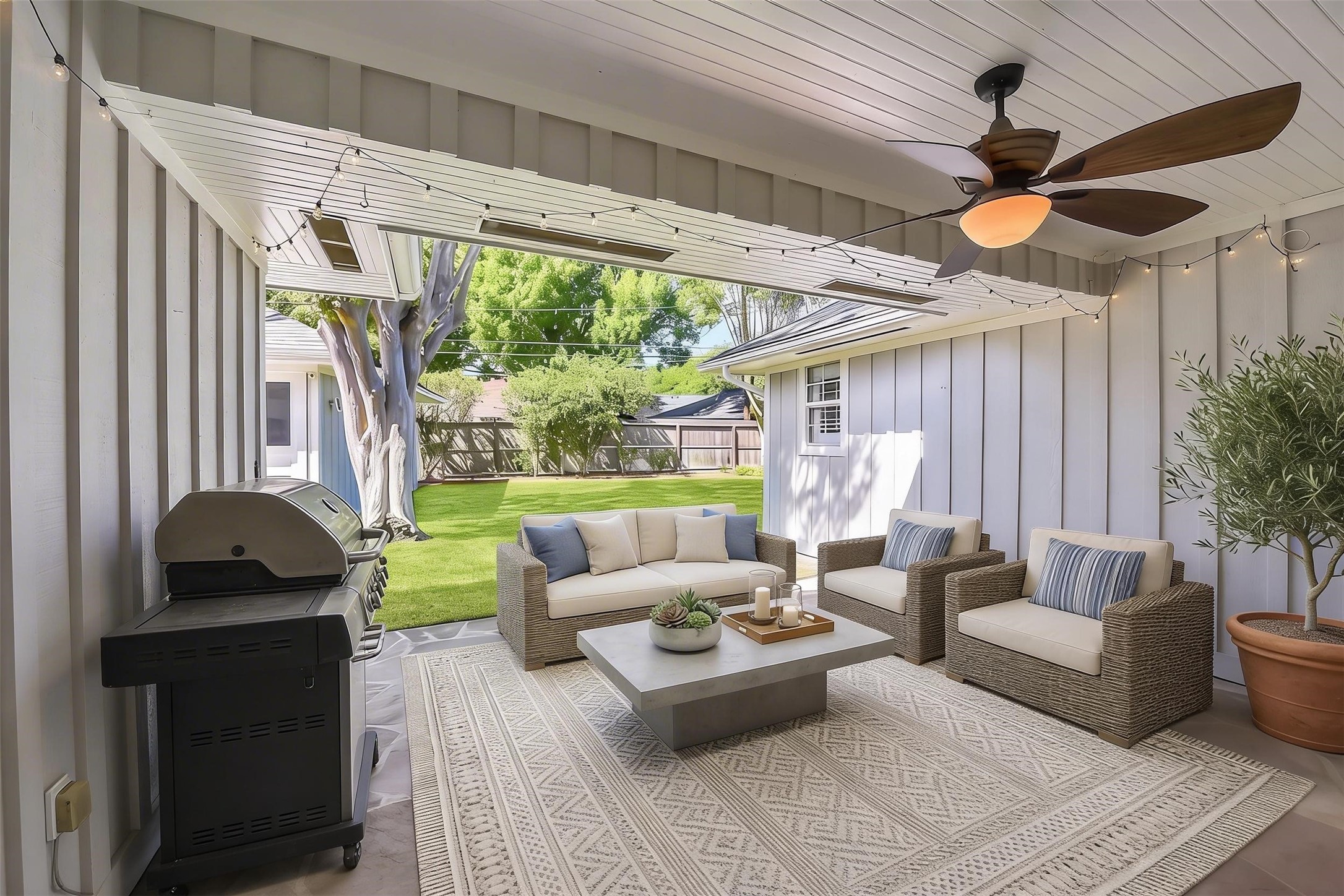 10026 Overbrook Lane Houston, TX 77042 - Photo 25 of 29 Covered patio designed for year-round enjoyment, featuring a ceiling fan and generous space for outdoor dining and entertaining. A seamless extension of the home’s living space, perfect for gathering and relaxing. This photo is virtually staged.