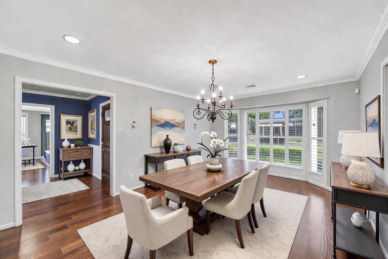 10026 Overbrook Lane Houston, TX 77042 - Photo 7 of 29 Just off the entry, a spacious and versatile formal living area designed to adapt to your needs—ideal as a dining room or additional gathering space. Elegant details include dental crown molding, recessed lighting, and a statement chandelier, while replaced bay windows (Sept. 2025) w/ plantation shutters fill the room w/ natural light. This photo is virtually staged.