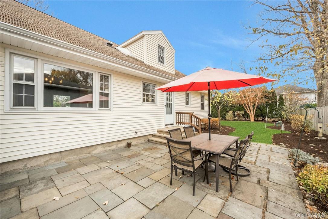 29 Old Orchard Road Rye Brook, NY 10573 - Photo 21 of 32 a view of a patio with a table and chairs under an umbrella