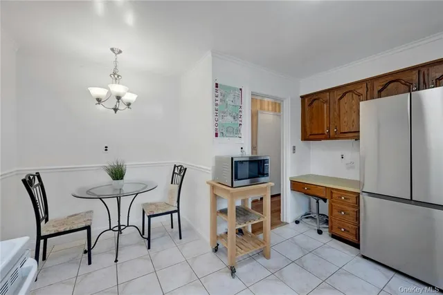 a kitchen that has a table chairs and a refrigerator