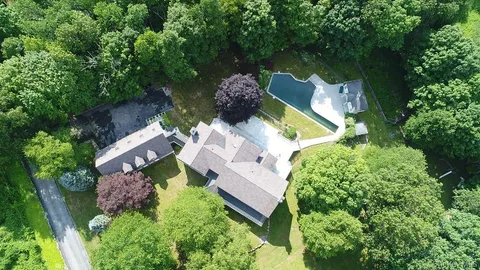 an aerial view of a house with a yard