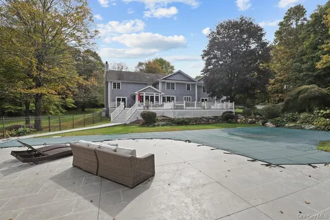 a view of swimming pool with outdoor seating and plants