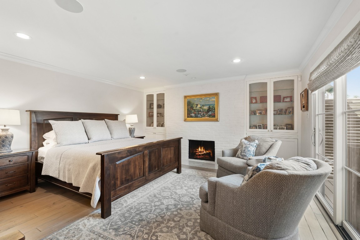 7606 Del Monte Drive Houston, TX 77063 - Photo 11 of 19 Tranquil primary bedroom retreat featuring wood-burning/gas fireplace, walk out terrace, private dressing area, custom built-ins, and sophisticated architectural details. Your personal sanctuary.