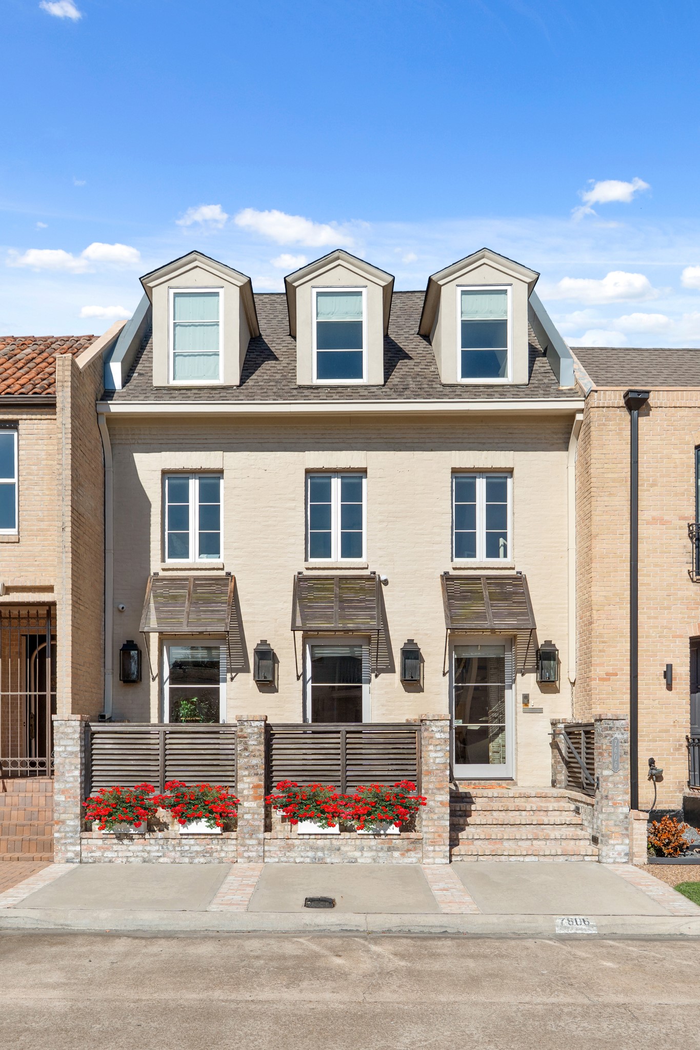 7606 Del Monte Drive Houston, TX 77063 - Photo 2 of 19 in Houston's exclusive Hammersmith community. Originally the first residence built by renowned architect Lucian Hood, this London brownstone-inspired masterpiece offers exceptional value in one of Memorial's most sought-after neighborhoods.Show-stopping custom glass staircase anchored by abundant natural light floods all levels through soaring windows, creating an architectural showpiece rarely found in Houston townhomes.