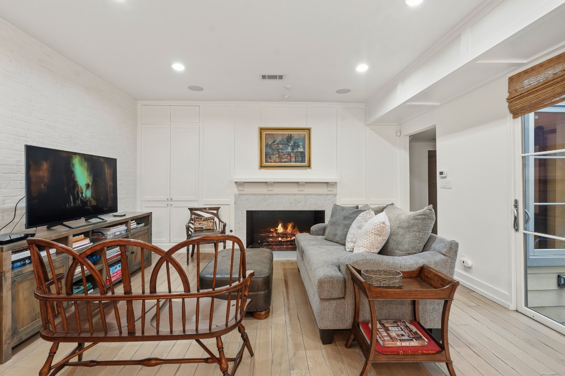 7606 Del Monte Drive Houston, TX 77063 - Photo 8 of 19 Den with fireplace anchors the open living, dining, and kitchen areas.