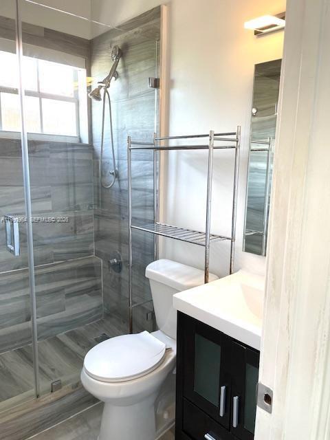 3356 Bird Avenue, Unit 10 Miami, FL 33133 - Photo 15 of 25 a bathroom with a sink toilet and shower