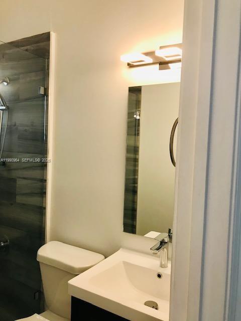 3356 Bird Avenue, Unit 10 Miami, FL 33133 - Photo 16 of 25 a bathroom with a sink a toilet and shower